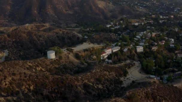 AERIAL: Beautiful shot over Hollywood Sign Letters looking at Downtown LA at Sunset, Los Angeles, California — Stock Video