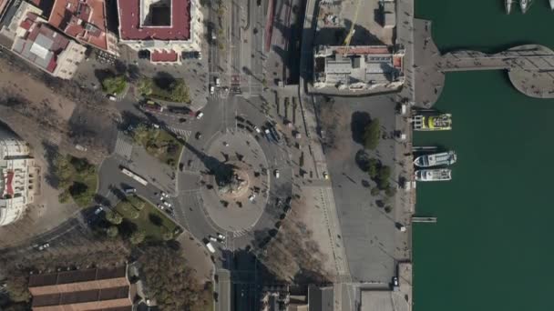 AERIAL: Overhead Shot of Columbus Monument Roundabout w Barcelonie, Hiszpania z ruchliwym ruchem samochodowym w słoneczny dzień — Wideo stockowe