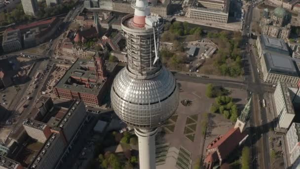 AERIAL: Wide View of the top of Alexander Platz TV Tower with Empty Berlin, Germany Streets in background on hot summer day during COVID-19 Corona Virus Pandemic — Stockvideo