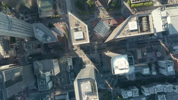 AERIAL: Epic slow lowering and circiling birds eye View over Downtown Los Angeles California in beautiful Sunrise Light with view of skyscraper rooftops and car traffic passing — Stock Video