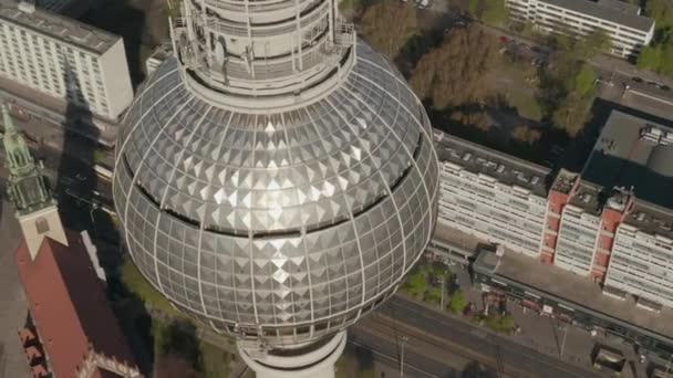 AERIAL: Wide View of the top of Alexander Platz TV Tower with Empty Berlin, Germany Streets in background on hot summer day during COVID-19 Corona Virus Pandemic — Stockvideo