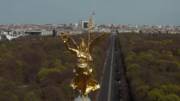 АЭРИАЛ: Заткнитесь вокруг Берлинской викторианской колонны Золотая статуя Виктории на фоне "Солнечного света" и Берлина, Германия, пейзаж Skyline на заднем плане — стоковое видео