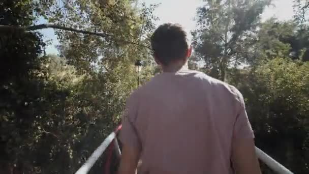 YOUNG CONFIDENT MEN WALKING TROUGH JUNGLE FOREST over BRIDGE IN MOROCCO ON SUNNY DAY — Stock video