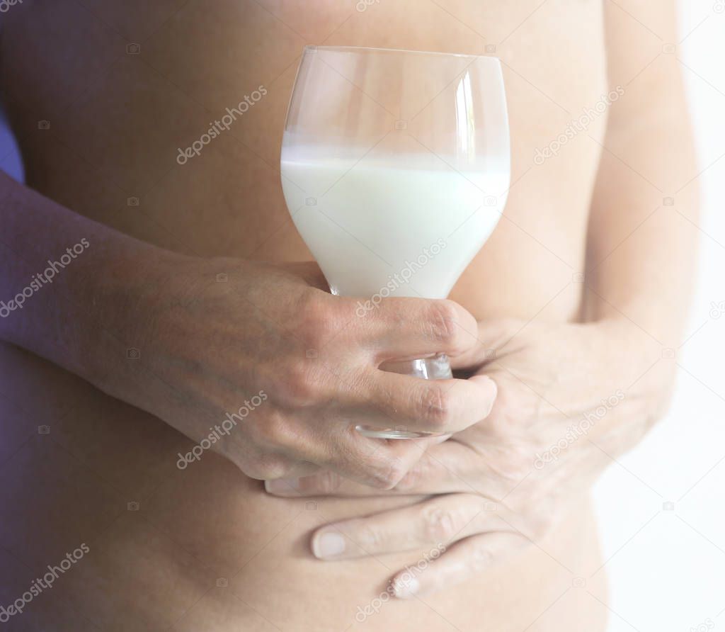 Holding a glass of milk - Milk Lactose Intolerance