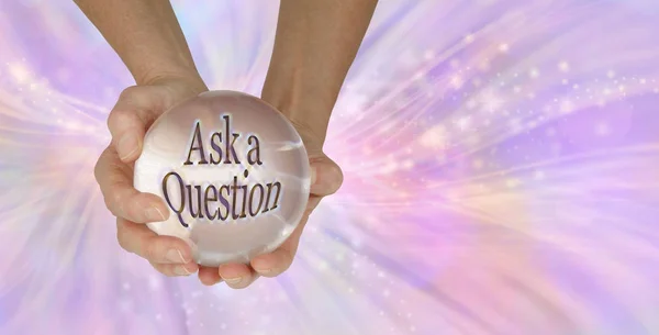 Go on - Ask me a Question - a female holding a large clear crystal ball with ASK A QUESTION within against a feminine pink swishing sparkling background with copy space