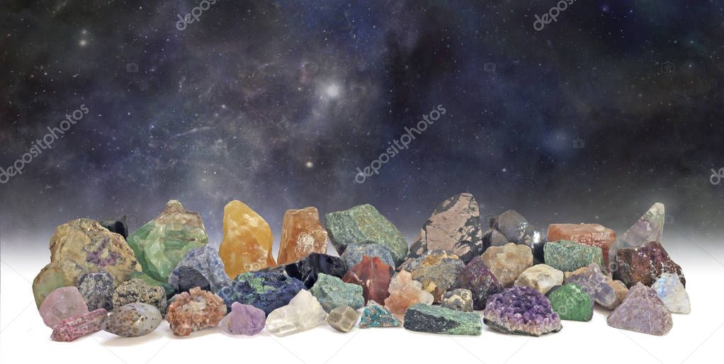 Cosmic Crystals Collection - dark deep space background with a neatly arranged collection of 40 different natural rough rock and gem specimens 
