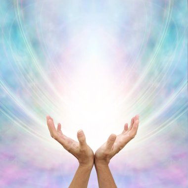Receiving Divine Source of Healing - hands cupped and facing up towards white light and blue pink energy formation background with copy space        clipart