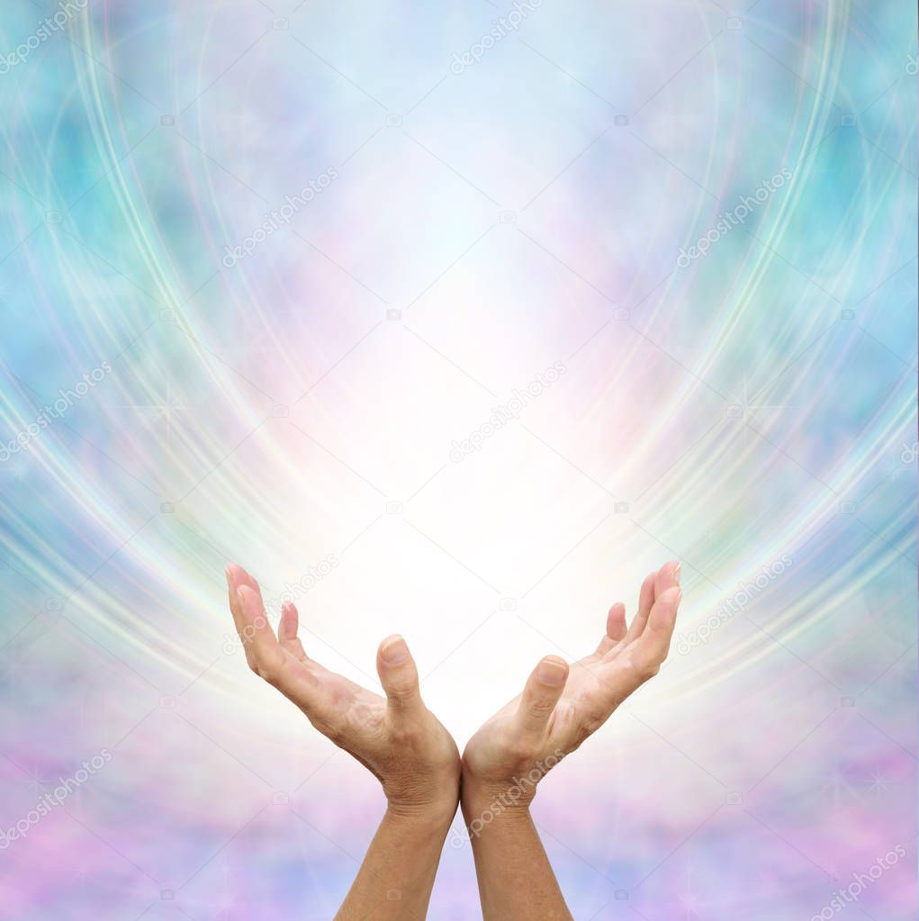 Receiving Divine Source of Healing - hands cupped and facing up towards white light and blue pink energy formation background with copy space       