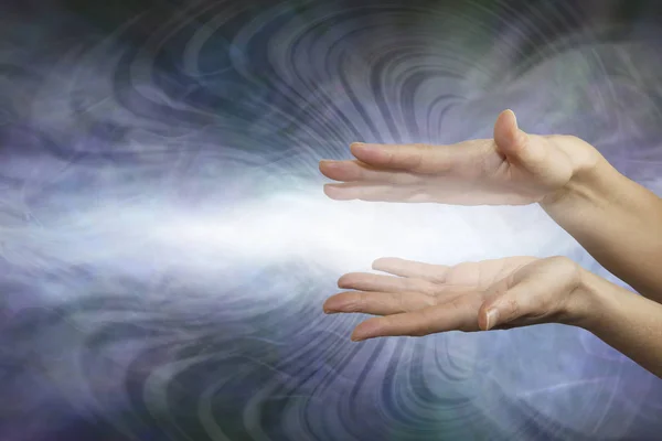 Everyone can feel and send energy with intention - female parallel hands beaming white light outwards against a grey background with copy space — Stock Image Everyone Can Feel Send Energy Intention Female Parallel Hands Beaming Royalty Free Stock Images