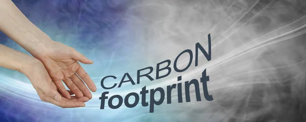 How big is your carbon footprint concept background - female hands with CARBON FOOTPRINT flowing from hands against a blue to grey flowing background