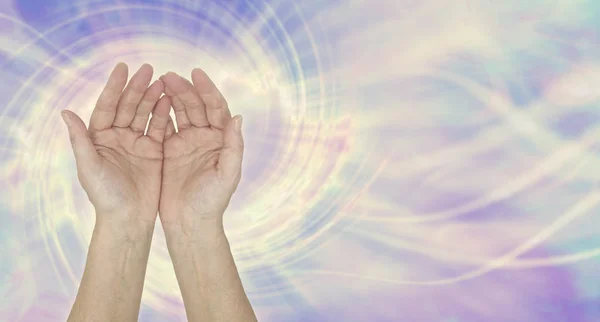 I am a channel for healing energy - female open palm hands against a multicoloured spiralling vortex energy field background with copy space — Stock Image Channel Healing Energy Female Open Palm Hands Multicoloured Spiralling Vortex Royalty Free Stock Images