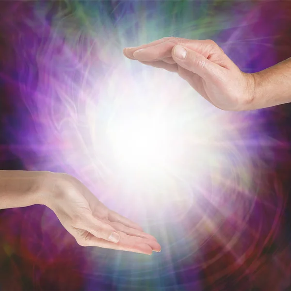 Together our healing energies combine to create a powerful influence - male hand opposite female hand with a white light orb in between against a multicoloured flowing energy field background with copy space — Stock Image Together Our Healing Energies Combine Create Powerful Influence Male Hand Stock Image