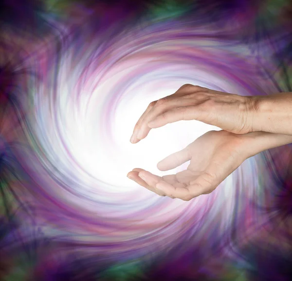 Healer with cleansing energy healing vortex - female energy worker with cupped hands sending out pure high energy vortex dispersing dark energies
