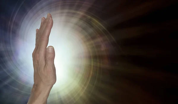Female healer with powerful palm chakra energy - upright open hand facing out with a spiral vortex energy radiating against a warm brown background with copy space on right — Stock Image Female Healer Powerful Palm Chakra Energy Upright Open Hand Facing Stock Photo