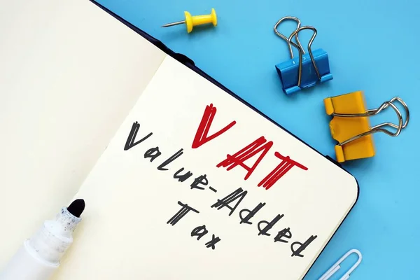 Financial concept meaning Value-Added Tax VAT with phrase on the piece of paper.