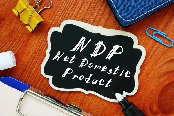 The photo says Net Domestic Product NDP. Notepad, pen, marker.