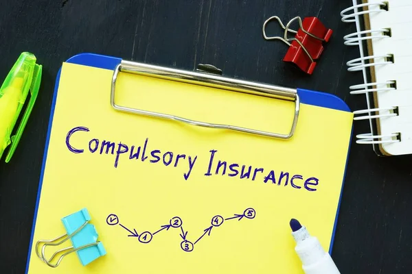 Financial concept meaning Compulsory Insurance with phrase on the piece of paper.