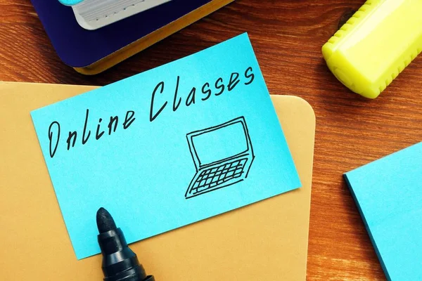 Educational concept meaning Online Classes with phrase on the piece of paper.