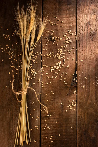a bouquet of wheat on a wooden table