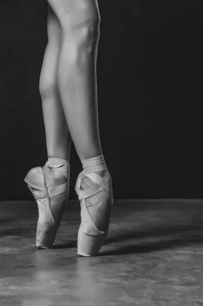 ballerina dancer shoes on the toes black and white on black background