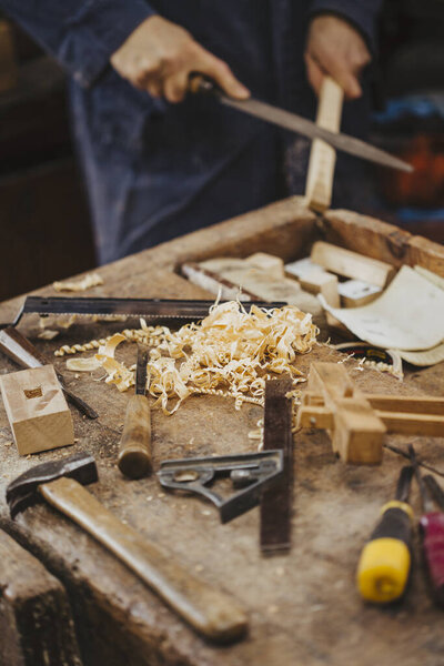 carpenter at work with woodworking tools