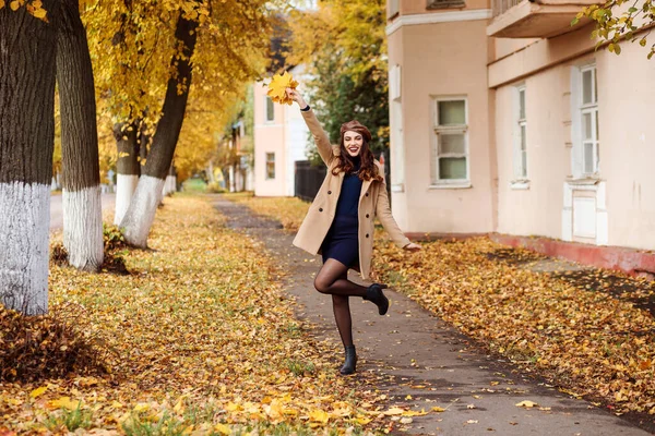 Fröhlich gestylte Frau amüsiert sich im Herbst draußen auf der Straße. — Stockfoto