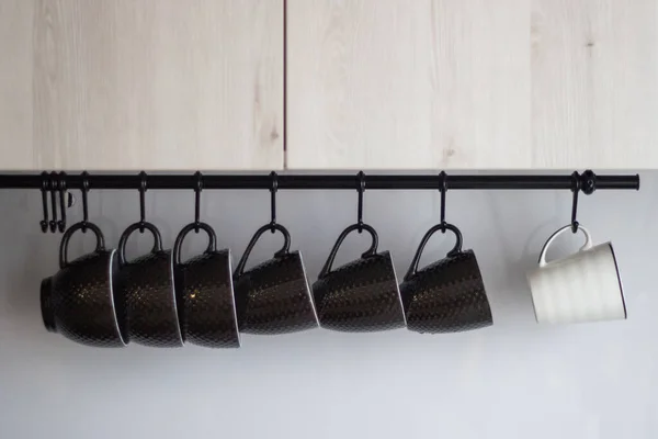 Several Brown Porcelain One White Mug Hanging Hooks Close Foreground — Stock Photo, Image