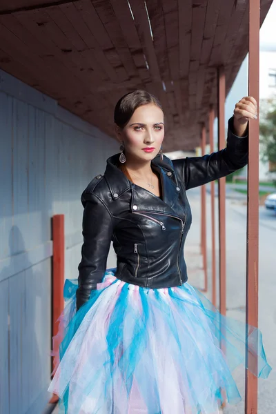 Beautiful shot of a girl with bright trendy makeup in black leather skirt in the style of glam rock — Stock Photo, Image