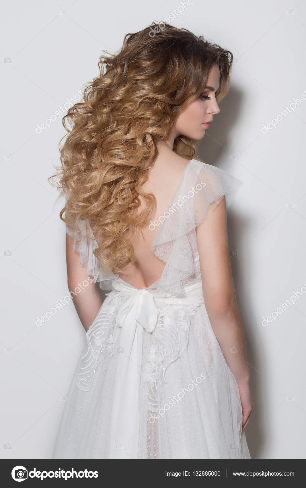 Beautiful fashionable hairstyles for young girls beautiful delicate bride  in a beautiful wedding dress on a white background in the studio Stock  Photo by ©Tanyunya2014 132885000