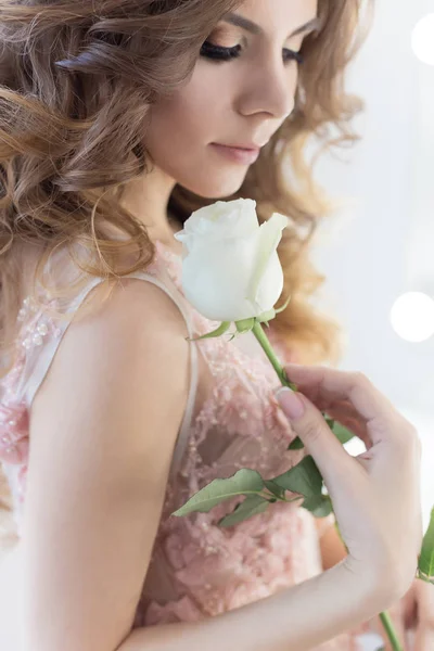 Beautiful sweet girl bride in a wedding dress with a pink air big curls and evening make-up, studio shot — Stock Photo, Image