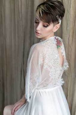 Güzel ihale cinsel kız gelin başında kısa saç kesimi nazik çelenk ayna yakınındaki keten sırtındaki dövme olan ile