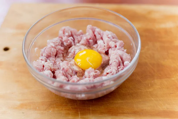 Cooked fresh mince for dish with raw egg lie in a plate — Stock Photo, Image