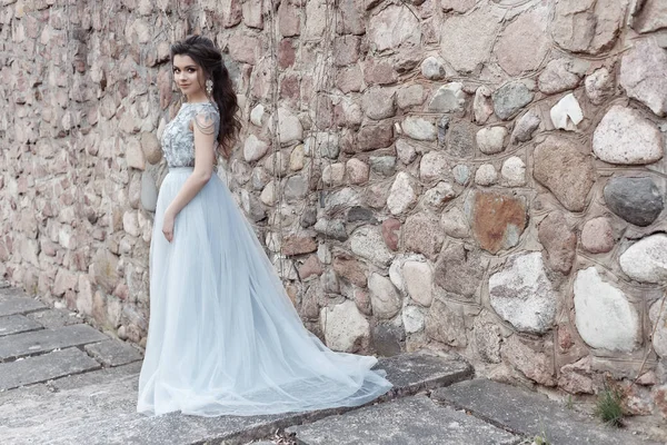Красива мила щаслива дівчина наречена в легкій весільній сукні, що йде в парку — стокове фото
