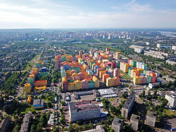 Colorful houses in Comfort Town district in Kyiv at cloudy weather. Aerial panoramic drone photo