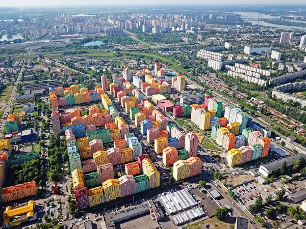 Colorful houses in Comfort Town district in Kyiv at cloudy weather. Aerial panoramic drone photo
