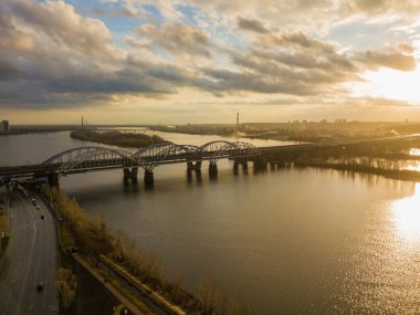 Günbatımında nehrin üzerinde modern köprü. Hava aracı görünümü