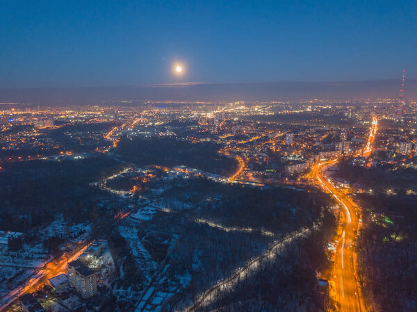 Aerial drone view. Evening illumination of snowy city of Kyiv