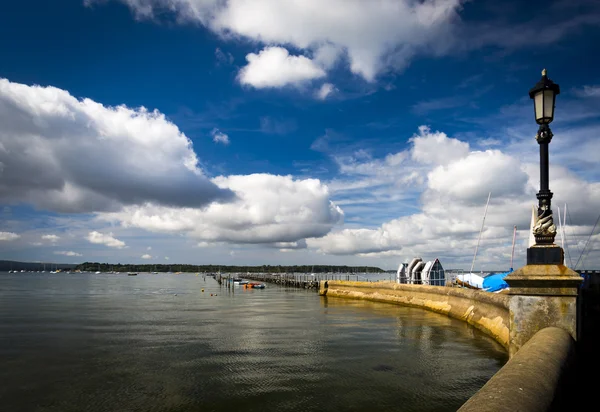White clouds and blue sky reflect on calm water at Sandbanks, Po — Stock Photo, Image