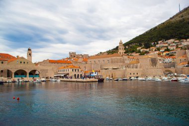 Hırvatistan 'ın Dubrovnik kentinin tarihi duvarı, güneşli bir günde kayalık kıyıda yer alıyor. 