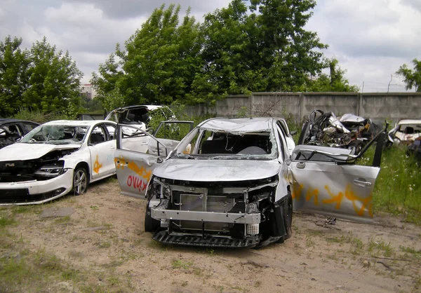 Total crash car parked on the street waiting for repair. Car crash wreck - insurance concept. Car destroyed. Claim the insurance company.