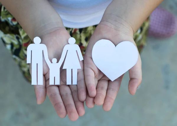 Children hands holding small model of heart and family , concept — Stock Photo, Image