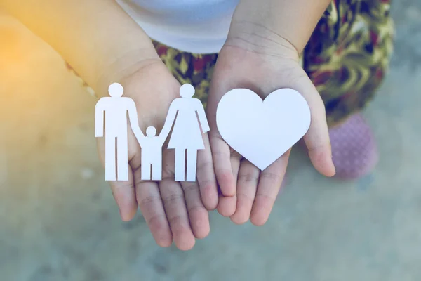 Children hands holding small model of heart and family , concept — Stock Photo, Image