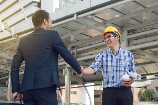 businessman worker handshaking on construction site