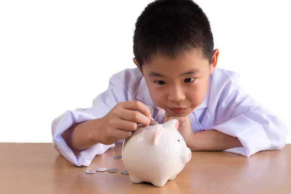 Asiatische Junge spielen als Arzt Balance Geld in Sparschwein, isola — Stockfoto