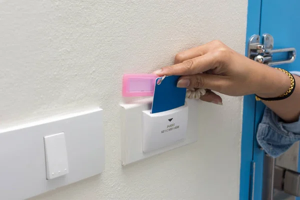 Asian women hand hold card for door access control scanning key