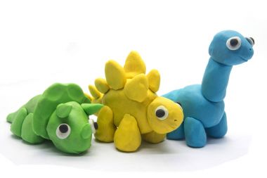 Play dough dinosaur on white background clipart