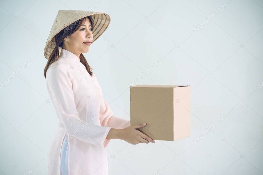 beautiful woman in pink dress and vietnam hat holding box