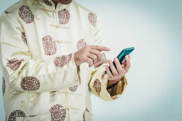 Asian man with cheongsam holding smartphone. — Stock Photo, Image