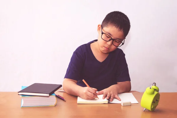 Asiático chico escribiendo un libro en la mesa — Foto de Stock