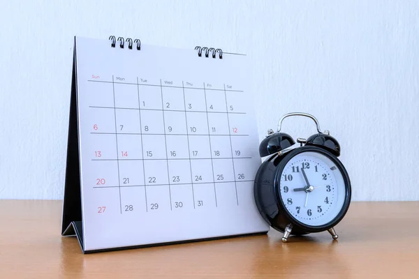 Calendar With Days and clock on wood table